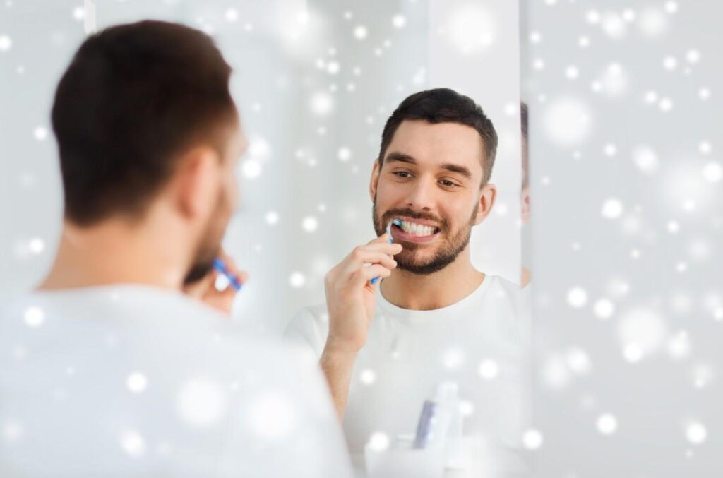 man brushing teeth during christmas holidays